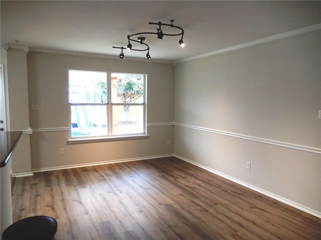 116 Rinehardt Street Hutto, TX 78634 - Photo 16 of 27 a view of an empty room with wooden floor and a window