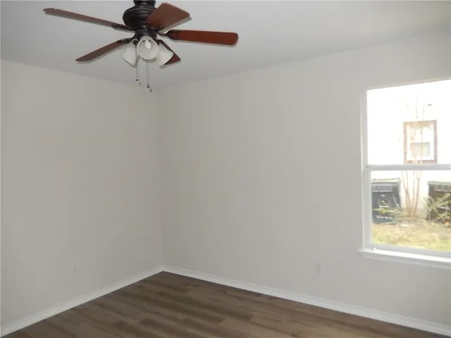 a view of a room with a window and wooden floor
