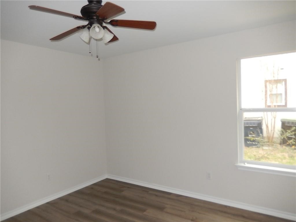116 Rinehardt Street Hutto, TX 78634 - Photo 20 of 27 a view of a room with a window and wooden floor