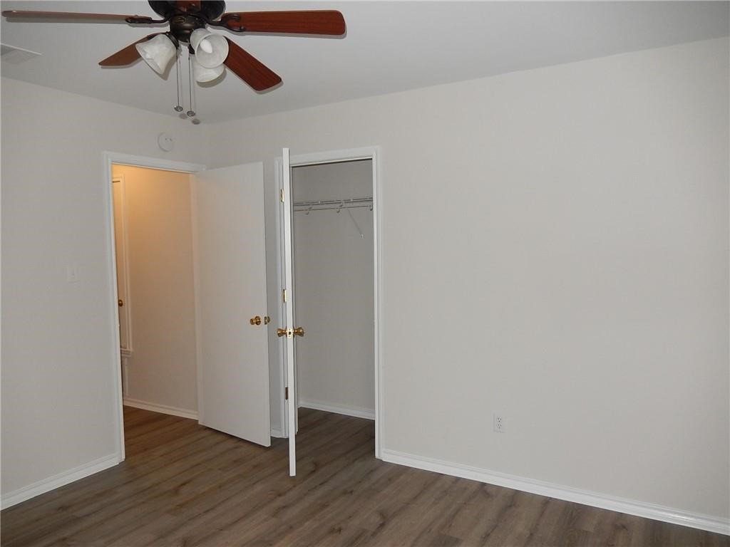 116 Rinehardt Street Hutto, TX 78634 - Photo 22 of 27 a view of empty room with wooden floor and ceiling fan