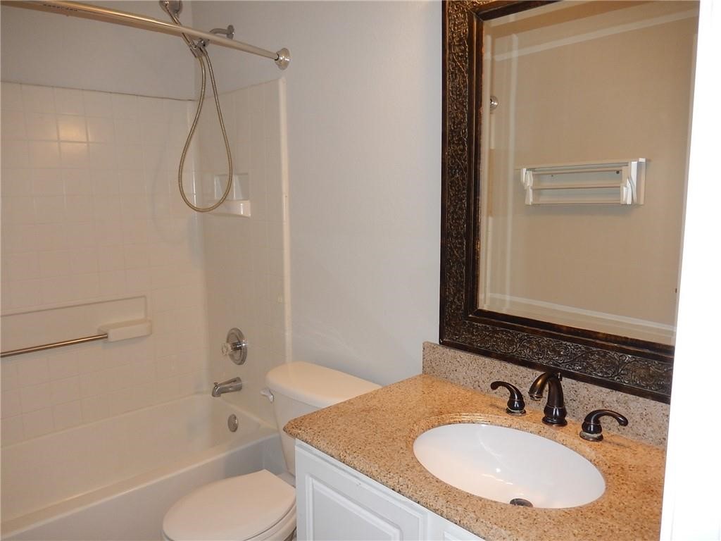 116 Rinehardt Street Hutto, TX 78634 - Photo 23 of 27 a bathroom with a granite countertop sink toilet and shower