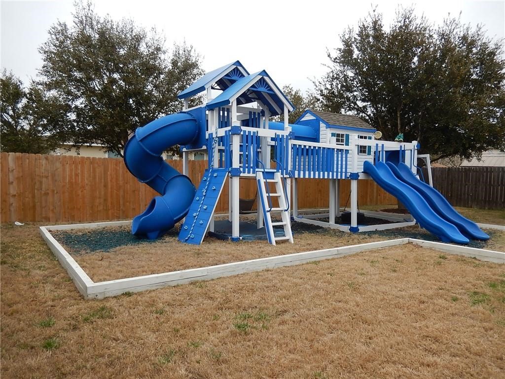 116 Rinehardt Street Hutto, TX 78634 - Photo 27 of 27 a view of a house with a yard and trees