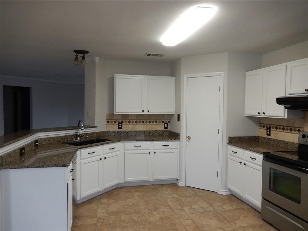 116 Rinehardt Street Hutto, TX 78634 - Photo 3 of 27 a kitchen with granite countertop a sink and a stove