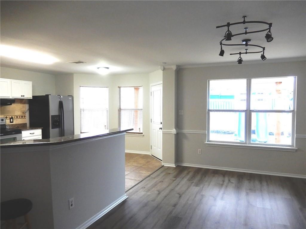 116 Rinehardt Street Hutto, TX 78634 - Photo 5 of 27 a view of a kitchen with wooden floor and windows