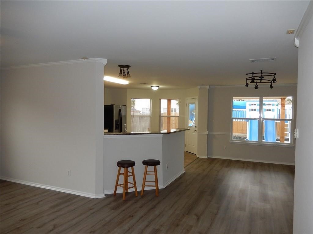 116 Rinehardt Street Hutto, TX 78634 - Photo 7 of 27 an empty room with wooden floor and windows