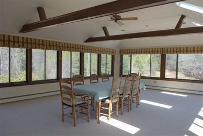 631 Quaker Road North Falmouth, MA 02556 - Photo 11 of 19 a view of a dining room with furniture large windows and wooden floor