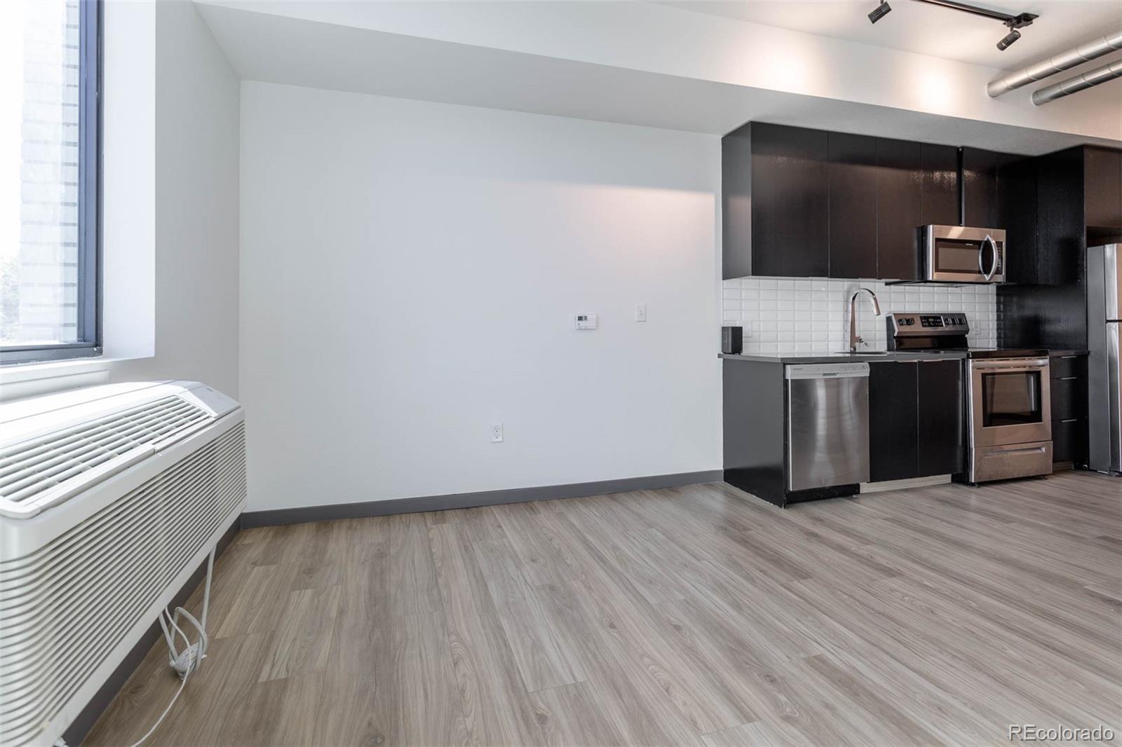 603 Inca Street, Unit 313 Denver, CO 80204 - Photo 11 of 20 a view of a kitchen with wooden floor and electronic appliances