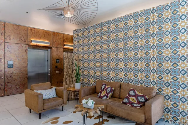 a living room with furniture and a chandelier