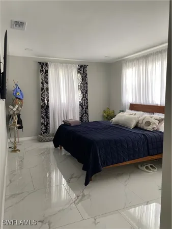 a bedroom with a large bed and a window