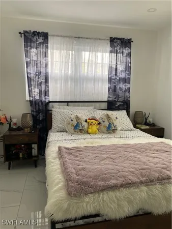 a bed sitting in a bedroom next to a window