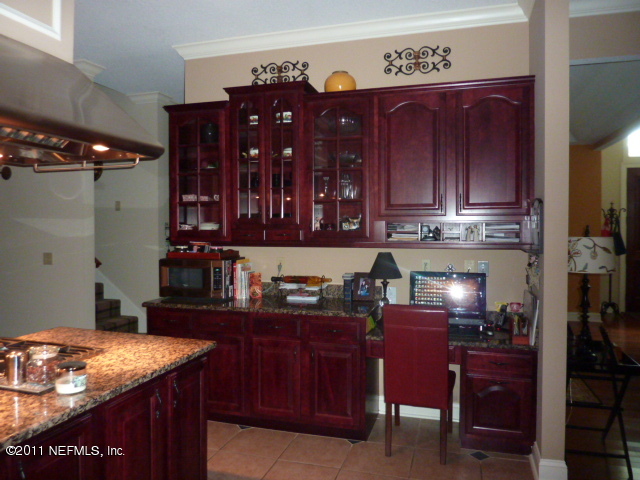 2545 County Dock Road Jacksonville, FL 32223 - Photo 17 of 62 a kitchen with a cabinets and chairs