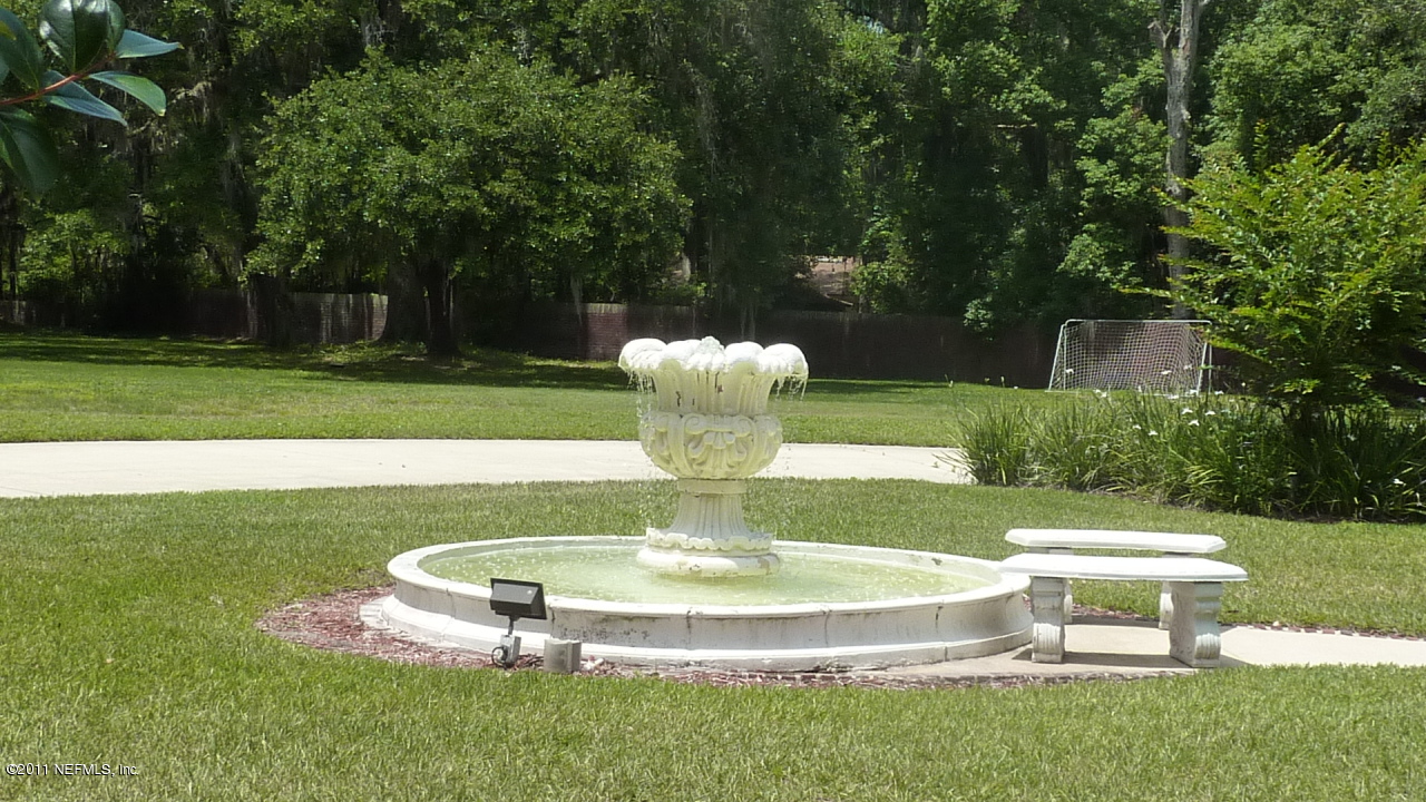 2545 County Dock Road Jacksonville, FL 32223 - Photo 3 of 62 a view of a fountain in a yard with palm trees