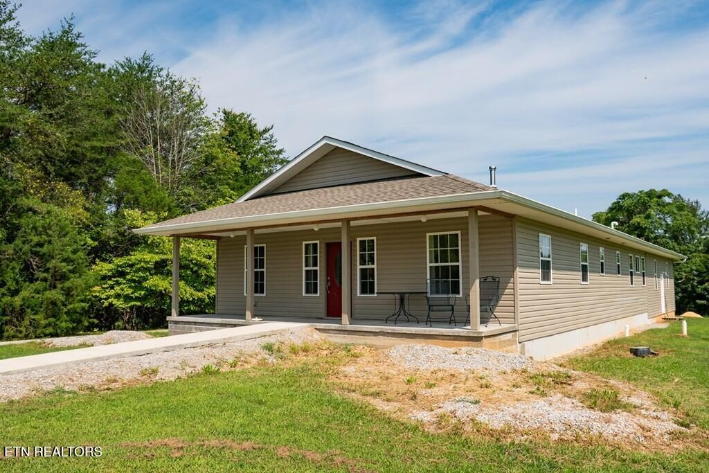 1518 Cummingsville And Sparkman Road Doyle, TN 38559 - Photo 41 of 58 a front view of a house with a yard