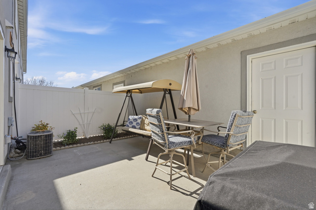 99 Penhurst Place Logan, UT 84341 - Photo 24 of 34 Private concrete patio area featuring a white privacy fence and a white panel door