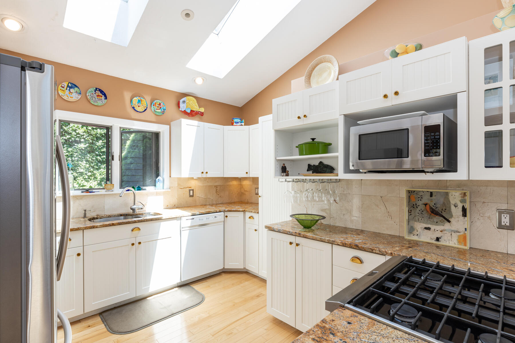 25 Adams Way Eastham, MA 02642 - Photo 12 of 60 a kitchen with stainless steel appliances a stove a sink and a microwave