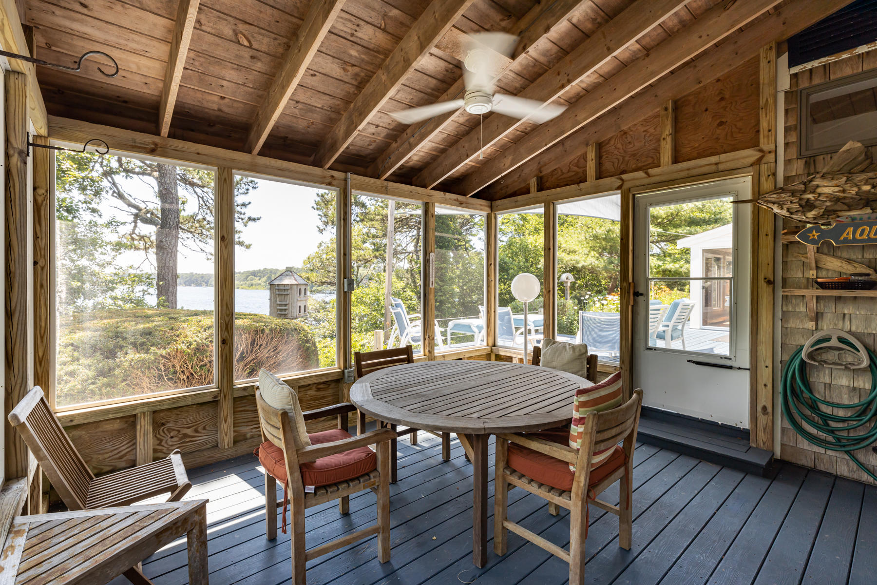 25 Adams Way Eastham, MA 02642 - Photo 16 of 60 a view of a dining room with furniture window and wooden floor