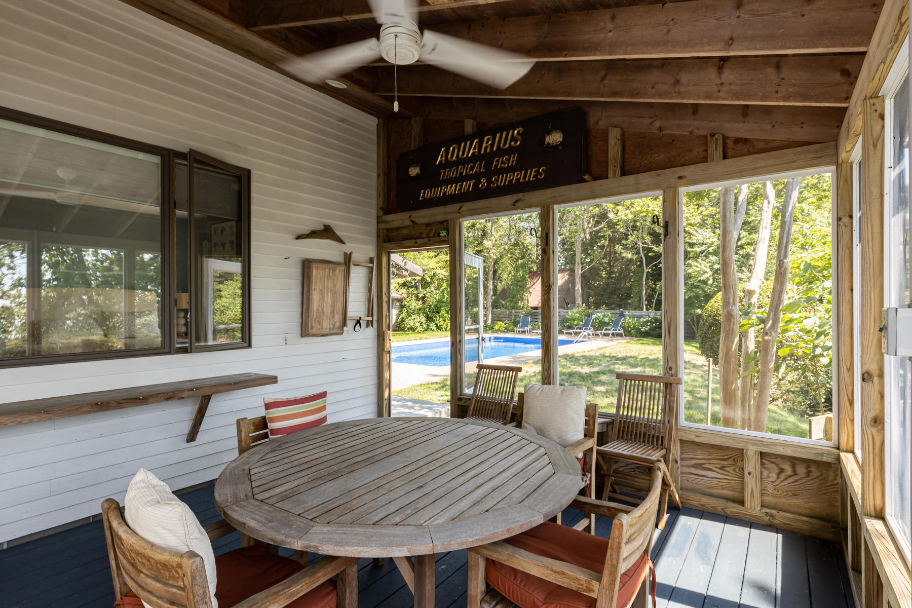 25 Adams Way Eastham, MA 02642 - Photo 17 of 60 a view of a patio with table and chairs a barbeque with wooden floor and floor