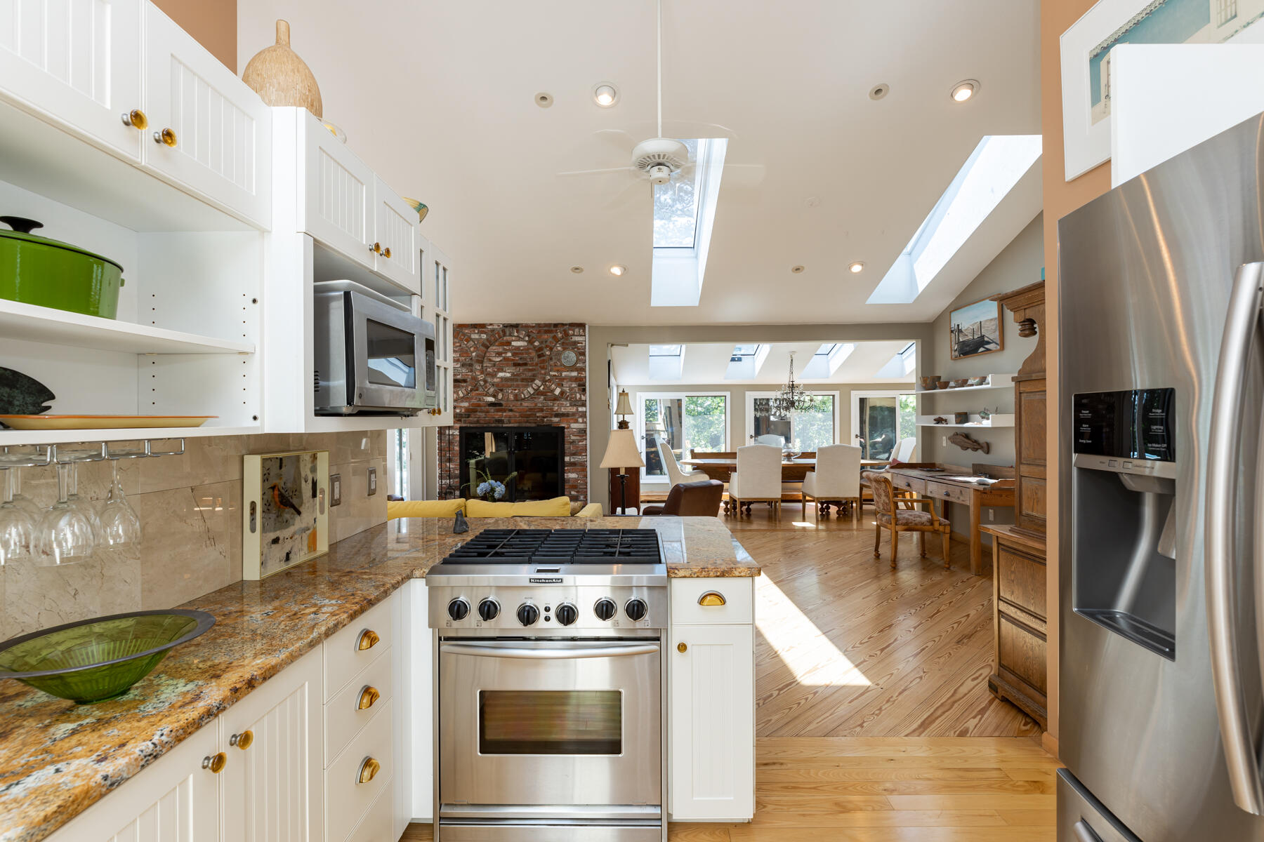 25 Adams Way Eastham, MA 02642 - Photo 19 of 60 a kitchen with stainless steel appliances granite countertop a stove a refrigerator a sink a stove and white cabinets