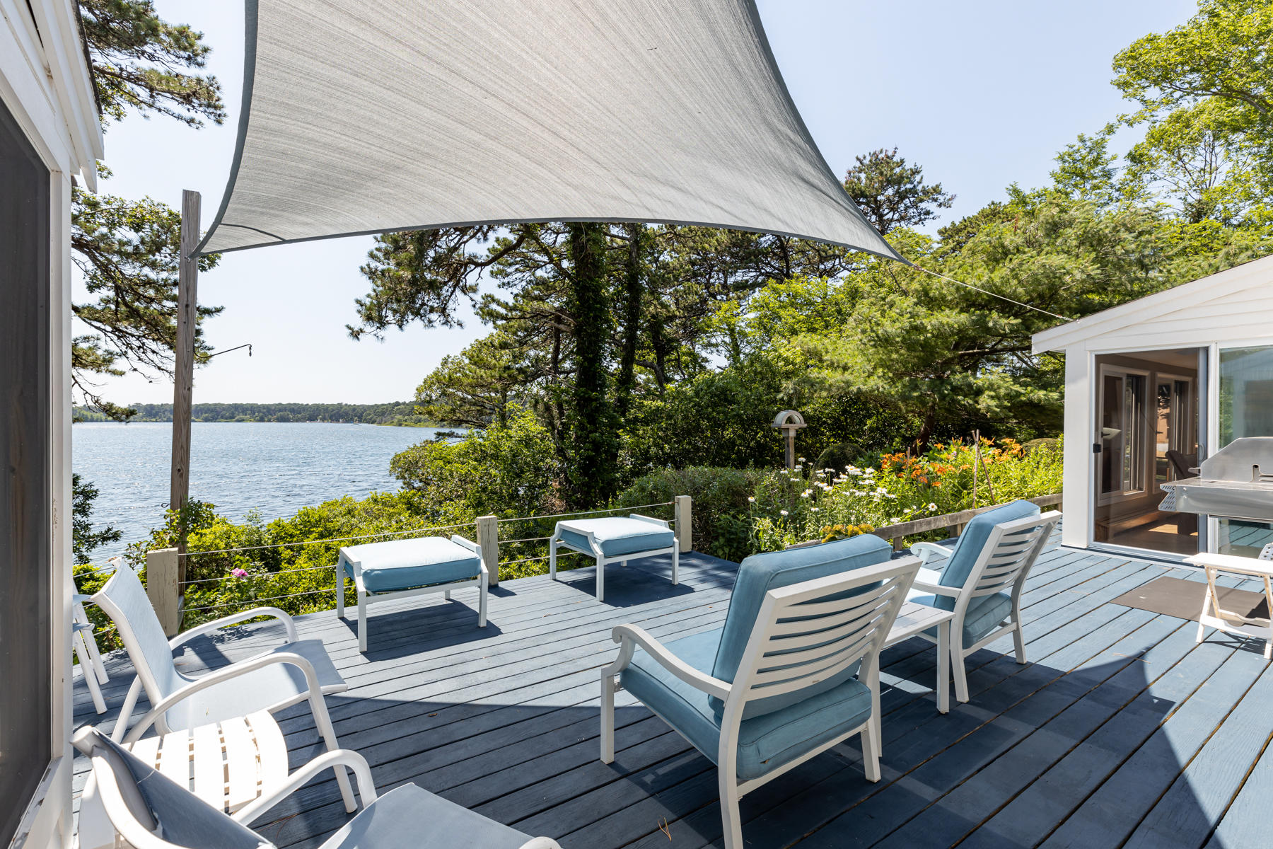 25 Adams Way Eastham, MA 02642 - Photo 5 of 60 an outdoor sitting area with furniture and a garden