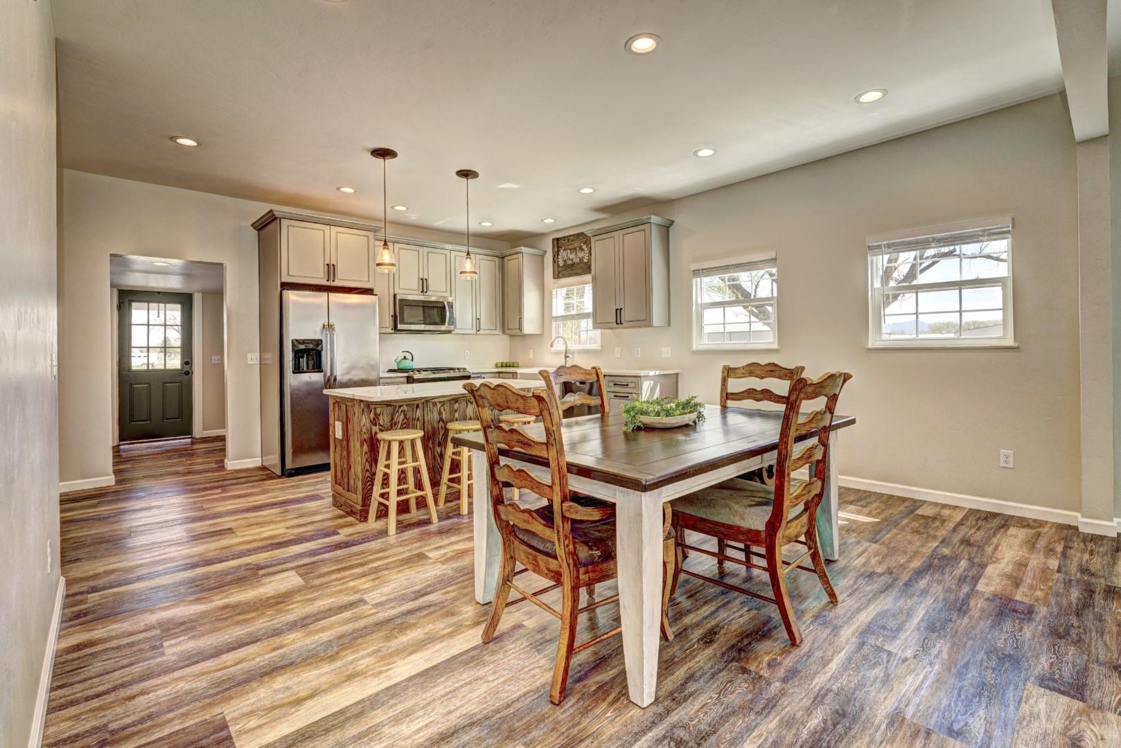 1151 19 Road Fruita, CO 81521 - Photo 3 of 25 a view of a dining room with furniture and wooden floor