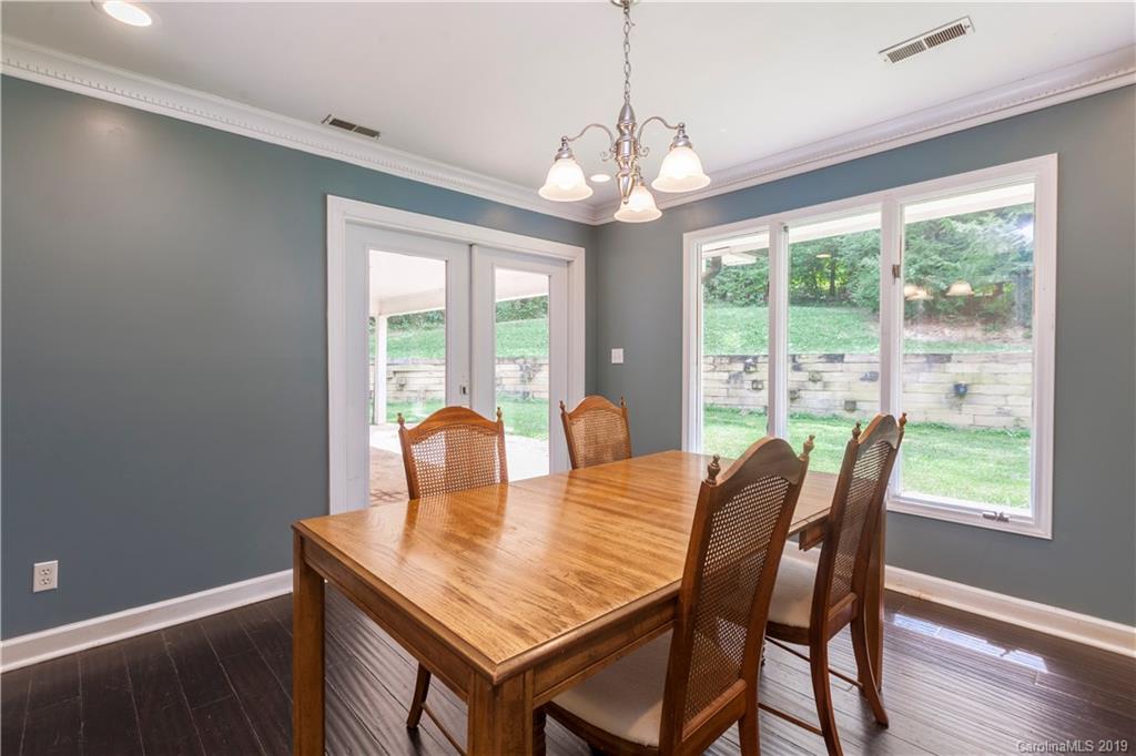 3515 Lake Shore Road South Denver, NC 28037 - Photo 15 of 46 a view of a dining room with furniture a chandelier and wooden floor