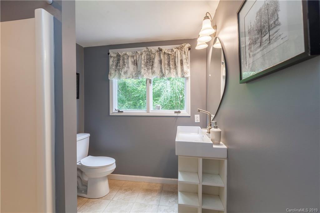 3515 Lake Shore Road South Denver, NC 28037 - Photo 26 of 46 a bathroom with a toilet sink and mirror