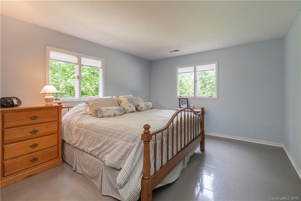 3515 Lake Shore Road South Denver, NC 28037 - Photo 28 of 46 a bedroom with a bed and a dresser next to a window