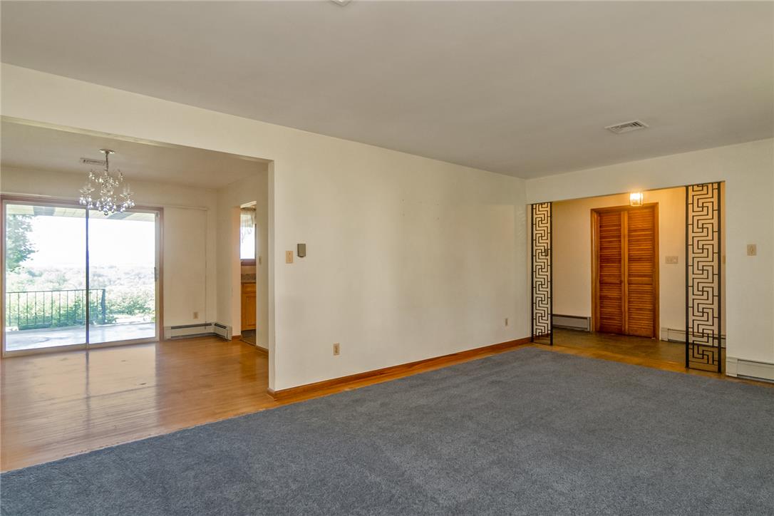1657 Clearview Road Coplay, PA 18037 - Photo 36 of 77 A well-lit living area features hardwood floors and a sliding glass door leading to a scenic outdoor space.