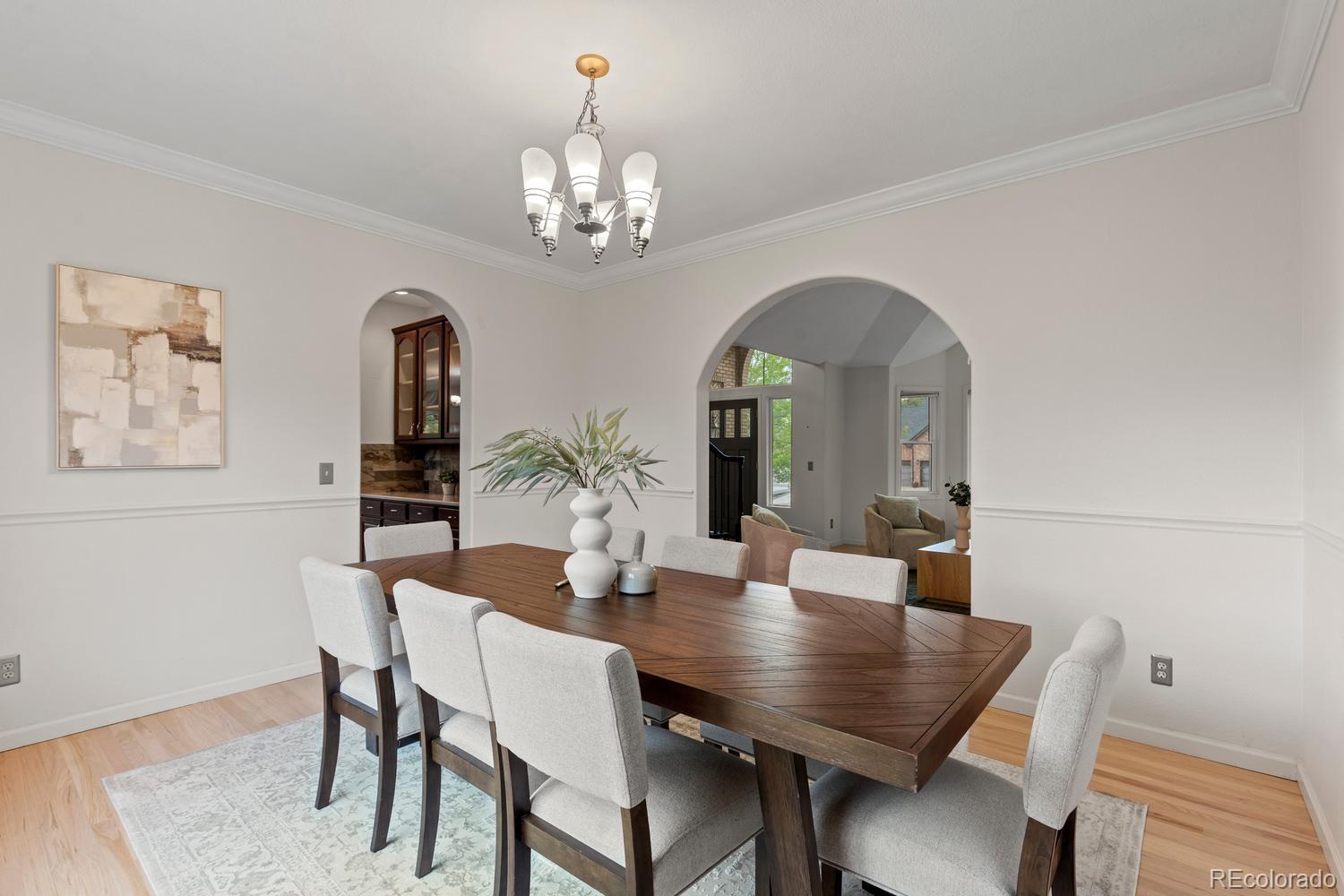 3900 Pierson Street Wheat Ridge, CO 80033 - Photo 7 of 39 a view of a dining room with furniture and chandelier