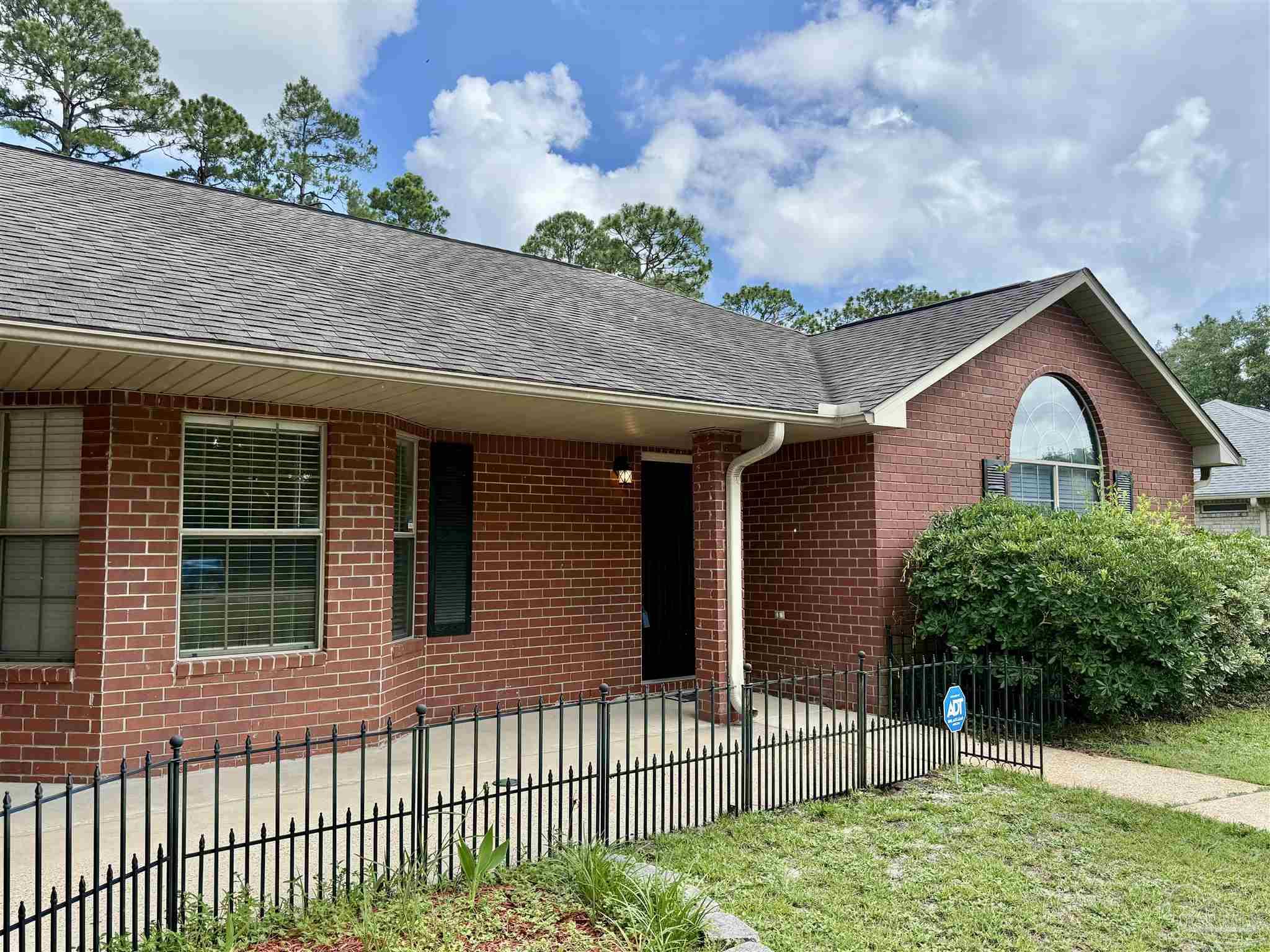 12465 Red Cloud Road Pensacola, FL 32507 - Photo 1 of 68 a front view of a house with a porch