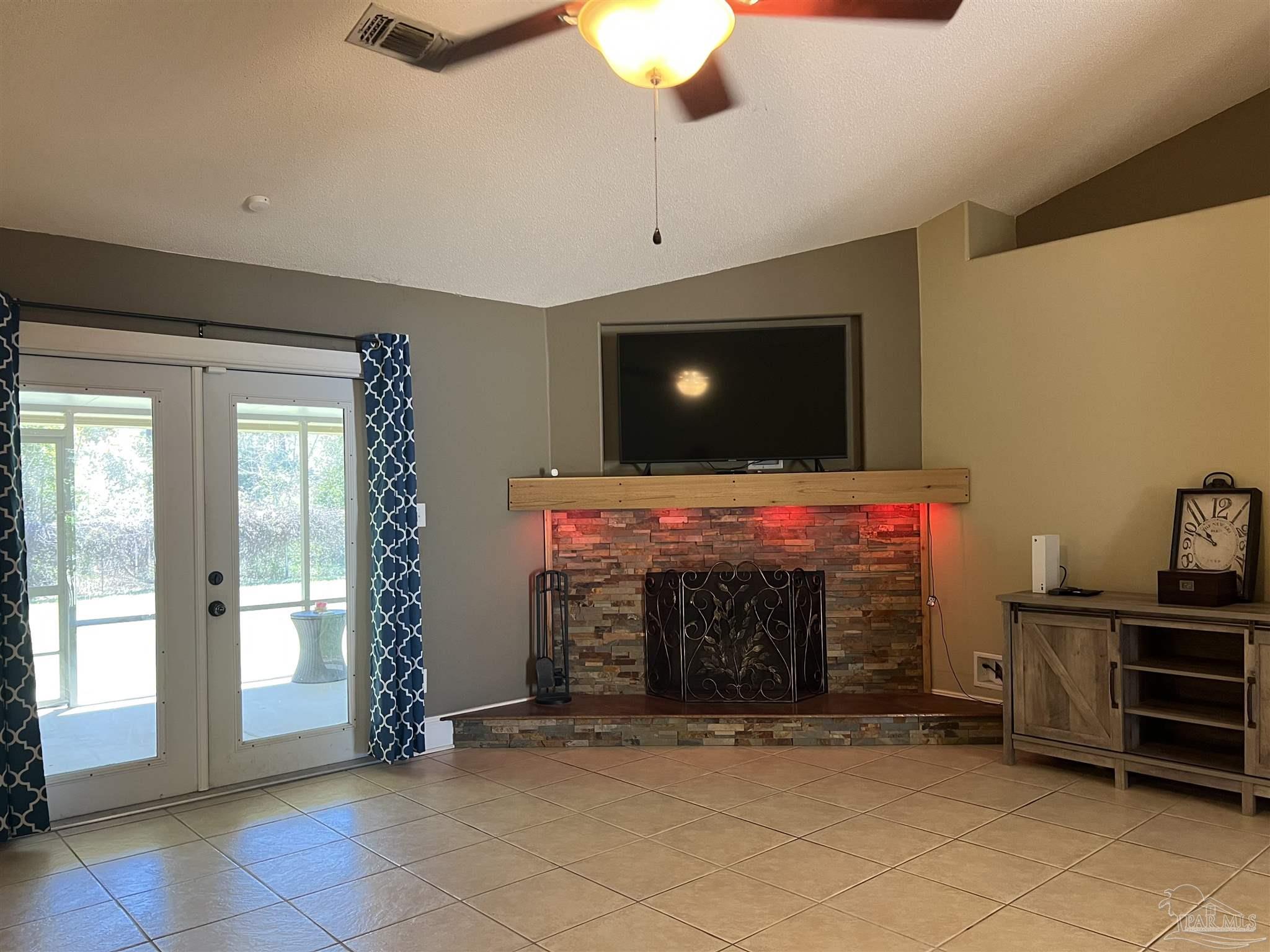 12465 Red Cloud Road Pensacola, FL 32507 - Photo 11 of 68 a room with furniture and a fireplace