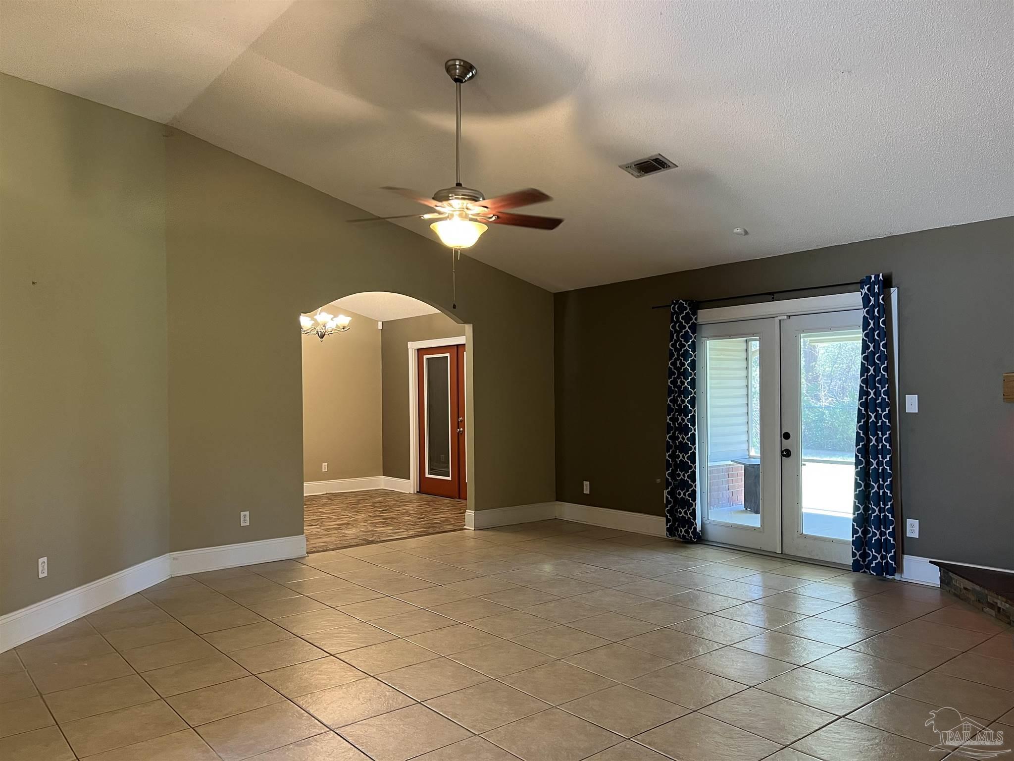 12465 Red Cloud Road Pensacola, FL 32507 - Photo 12 of 68 a view of a livingroom with a chandelier fan and windows