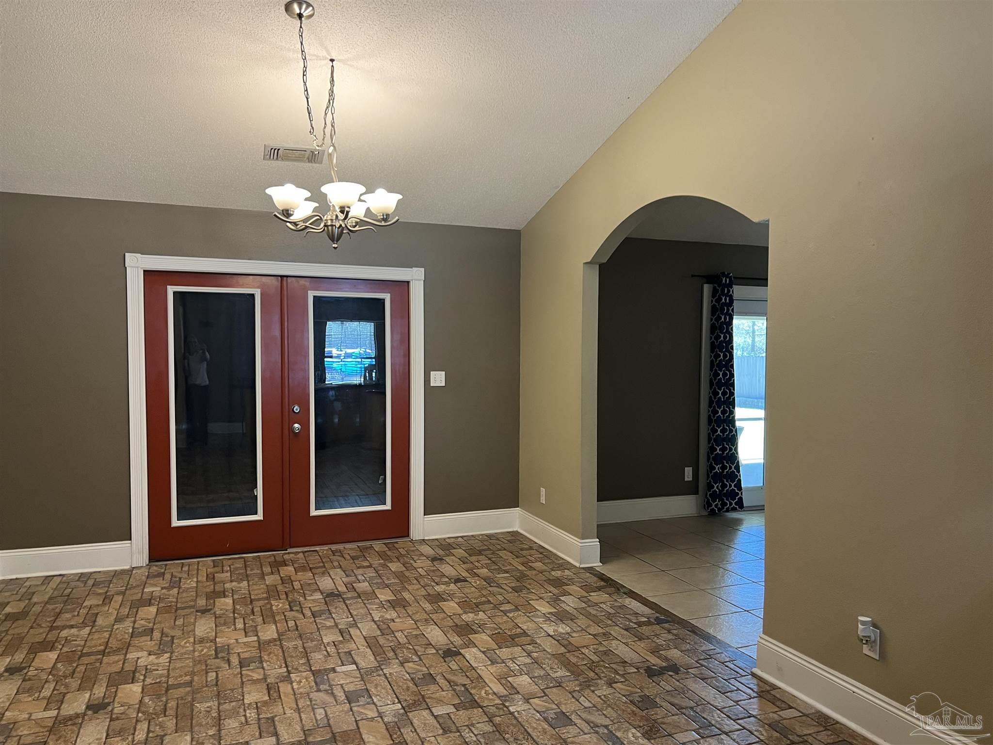12465 Red Cloud Road Pensacola, FL 32507 - Photo 15 of 68 a view of a hallway with a chandelier