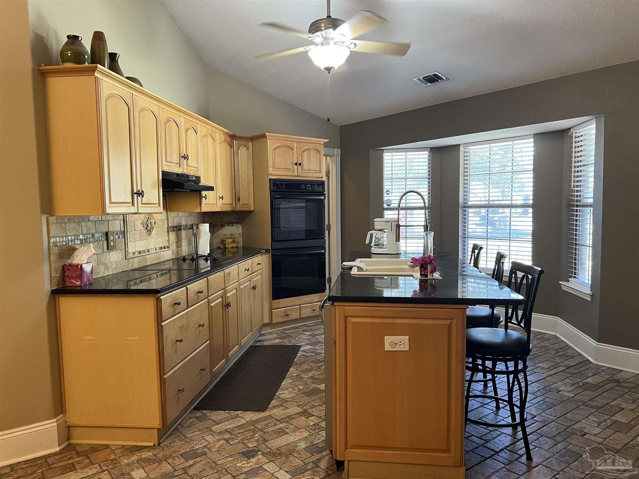 12465 Red Cloud Road Pensacola, FL 32507 - Photo 19 of 68 a kitchen with stainless steel appliances granite countertop a sink stove and refrigerator