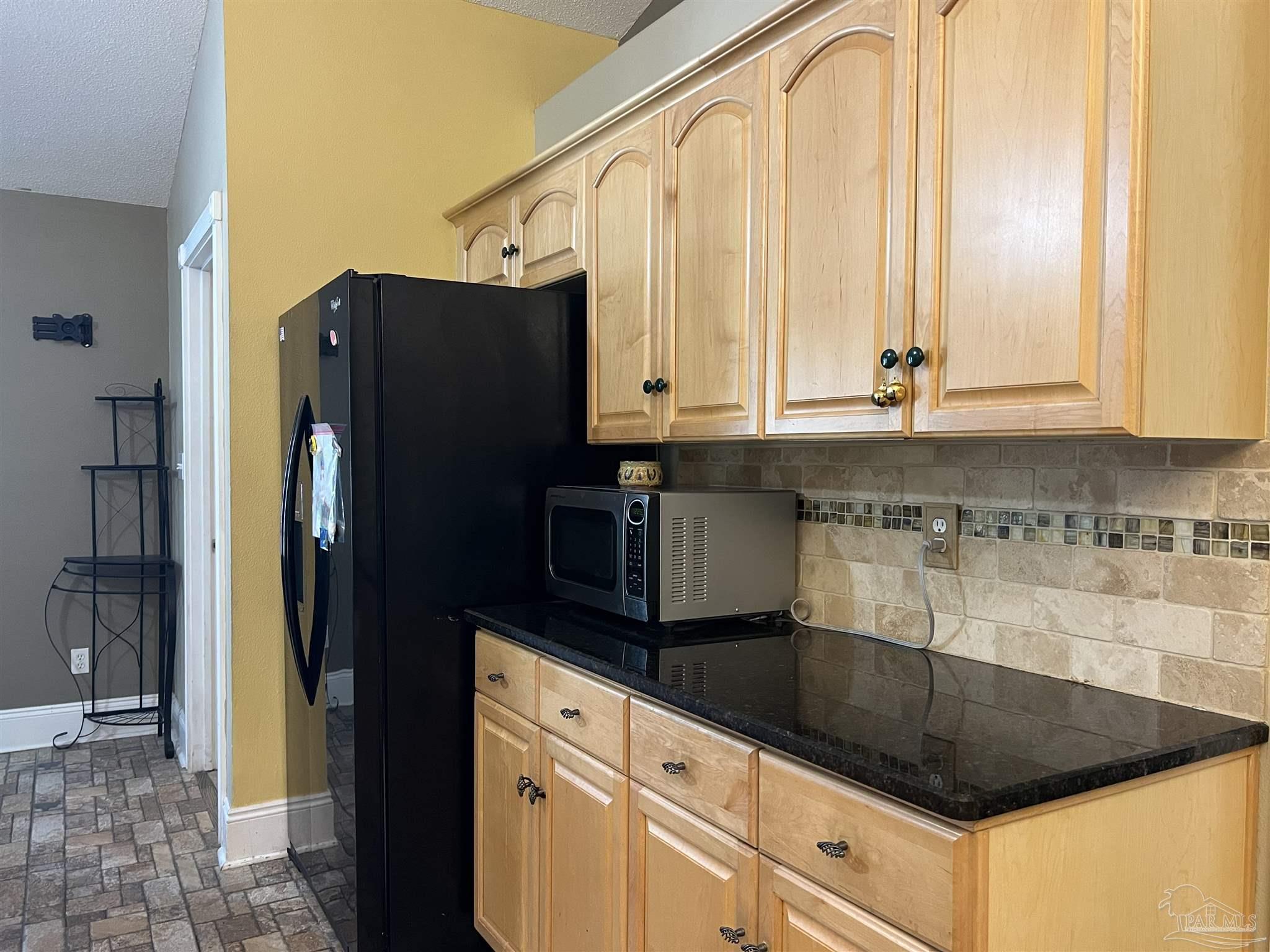 12465 Red Cloud Road Pensacola, FL 32507 - Photo 25 of 68 a kitchen with granite countertop a refrigerator and a sink