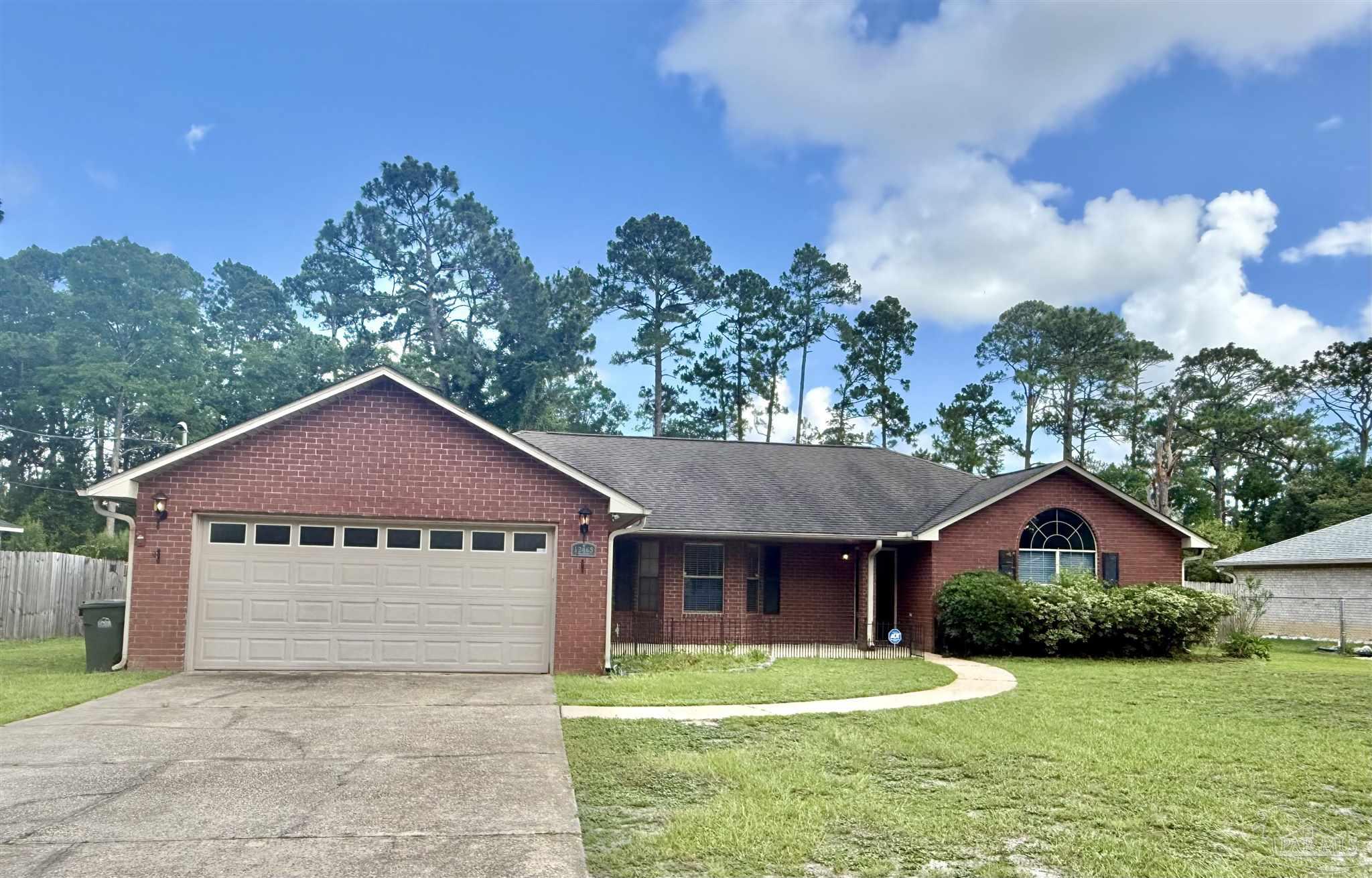 12465 Red Cloud Road Pensacola, FL 32507 - Photo 3 of 68 a front view of a house with a yard and garage