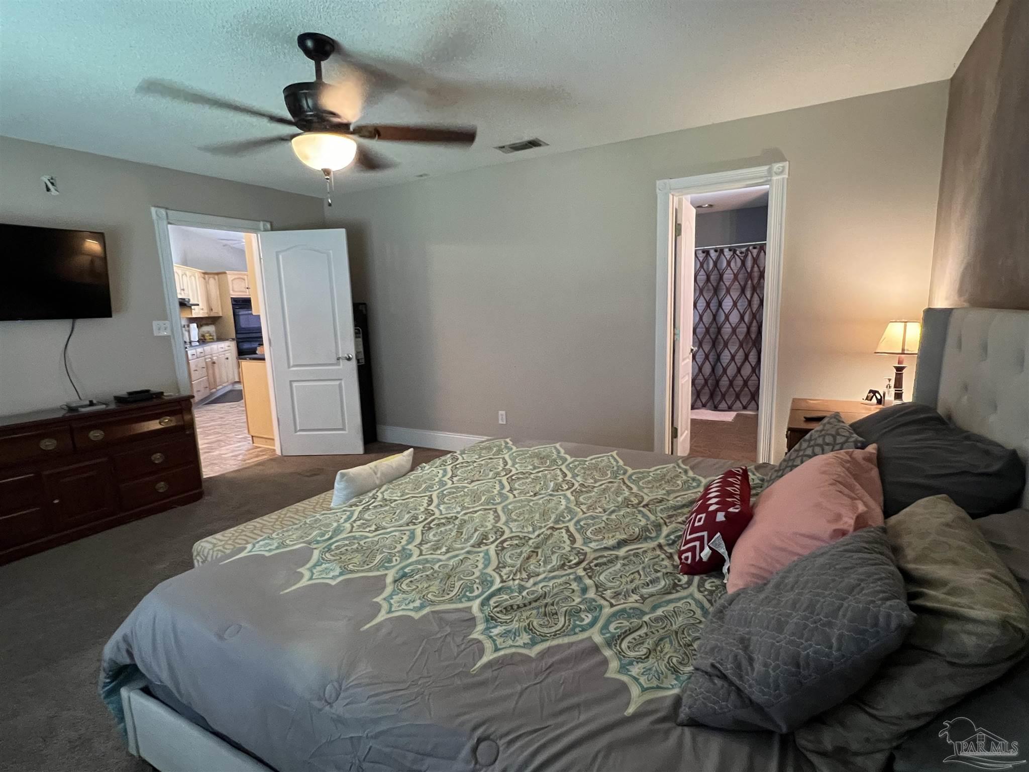 12465 Red Cloud Road Pensacola, FL 32507 - Photo 37 of 68 a bedroom with a bed and a flat screen tv