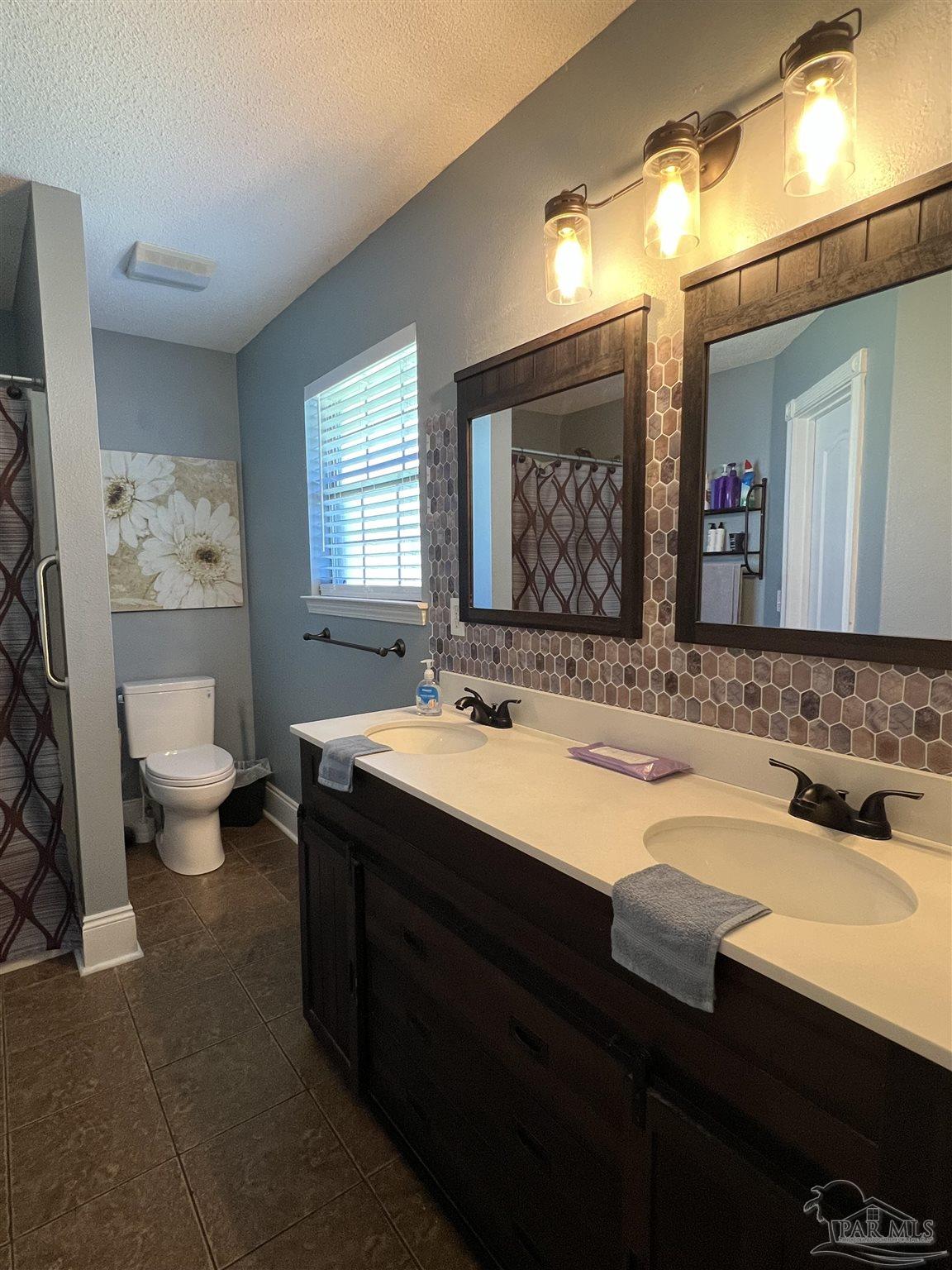 12465 Red Cloud Road Pensacola, FL 32507 - Photo 38 of 68 a bathroom with a sink and a mirror