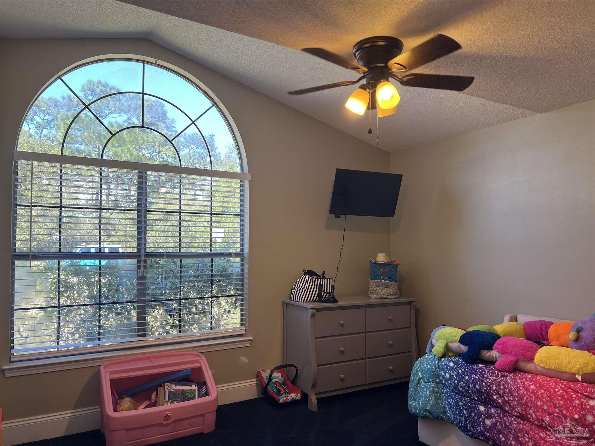 12465 Red Cloud Road Pensacola, FL 32507 - Photo 47 of 68 a bedroom with a bed and a chandelier