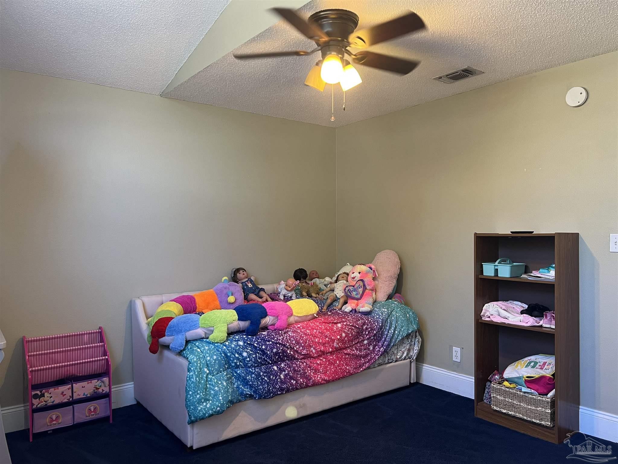 12465 Red Cloud Road Pensacola, FL 32507 - Photo 48 of 68 a bedroom with a bed and a chandelier
