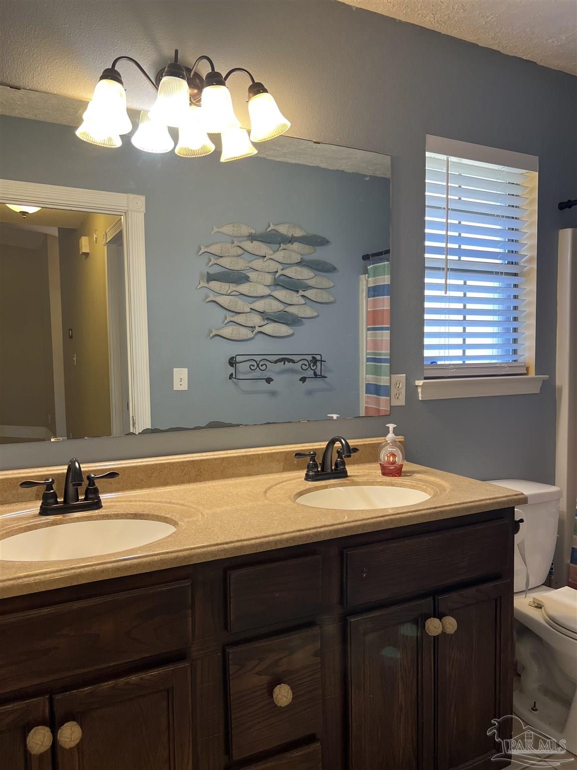 12465 Red Cloud Road Pensacola, FL 32507 - Photo 52 of 68 a bathroom with a double vanity sink and a mirror