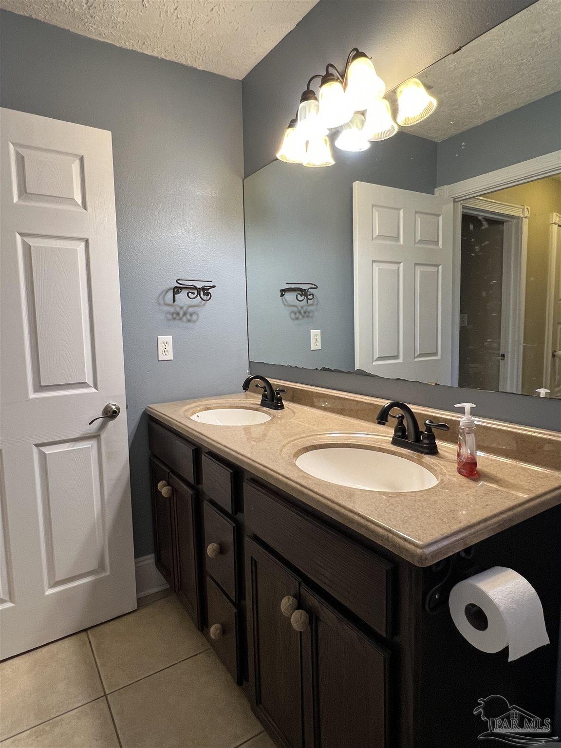 12465 Red Cloud Road Pensacola, FL 32507 - Photo 54 of 68 a bathroom with a double vanity sink and a mirror