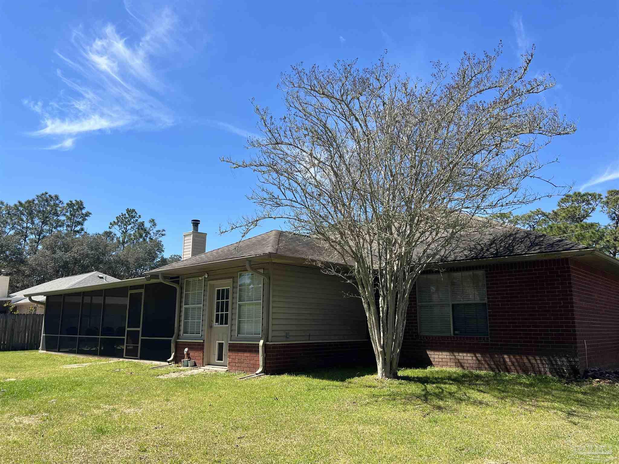 12465 Red Cloud Road Pensacola, FL 32507 - Photo 58 of 68 a view of a house with a yard