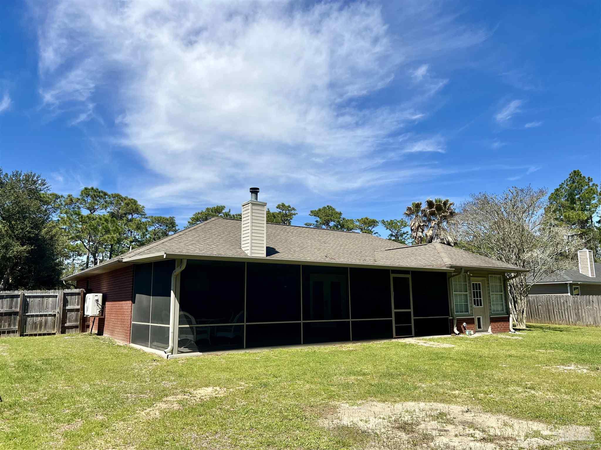 12465 Red Cloud Road Pensacola, FL 32507 - Photo 59 of 68 a view of a house with a yard and sitting area