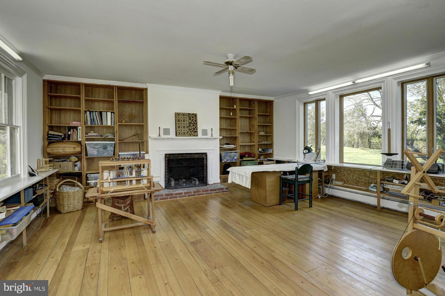 16501 Comus Road Dickerson, MD 20842 - Photo 3 of 29 a living room with furniture a fireplace and large windows