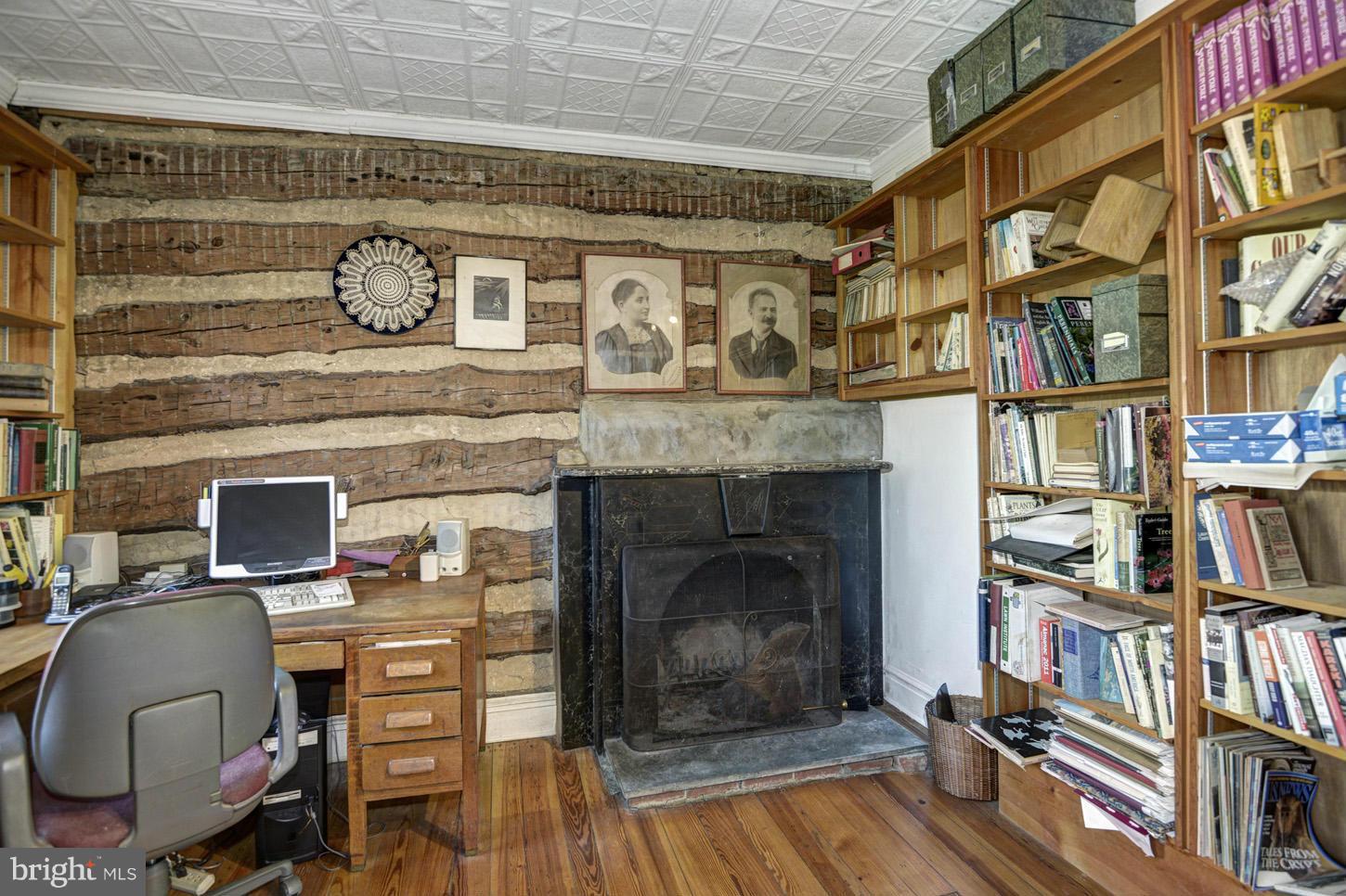 16501 Comus Road Dickerson, MD 20842 - Photo 7 of 29 a living room with a fireplace and a book shelf