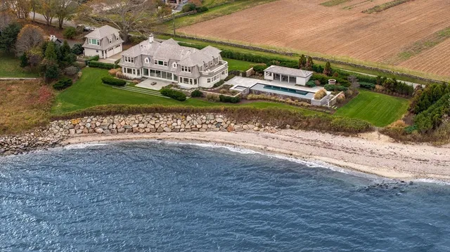 an aerial view of a house with a yard and lake view