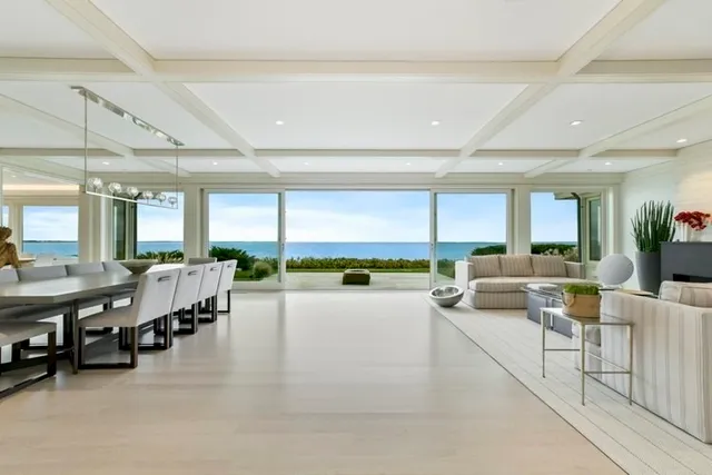 a living room with lots of furniture and a large window