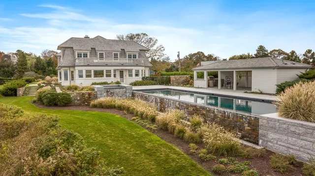 a view of a house with pool garden and sitting area