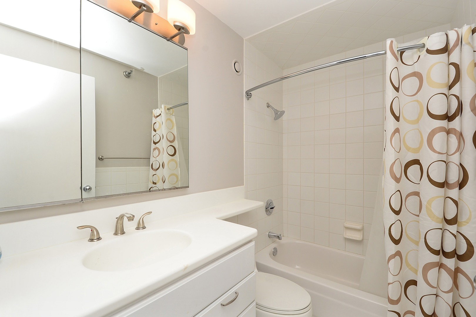 1122 North Clark Street, Unit 1203 Chicago, IL 60610 - Photo 13 of 22 a bathroom with a sink and a mirror